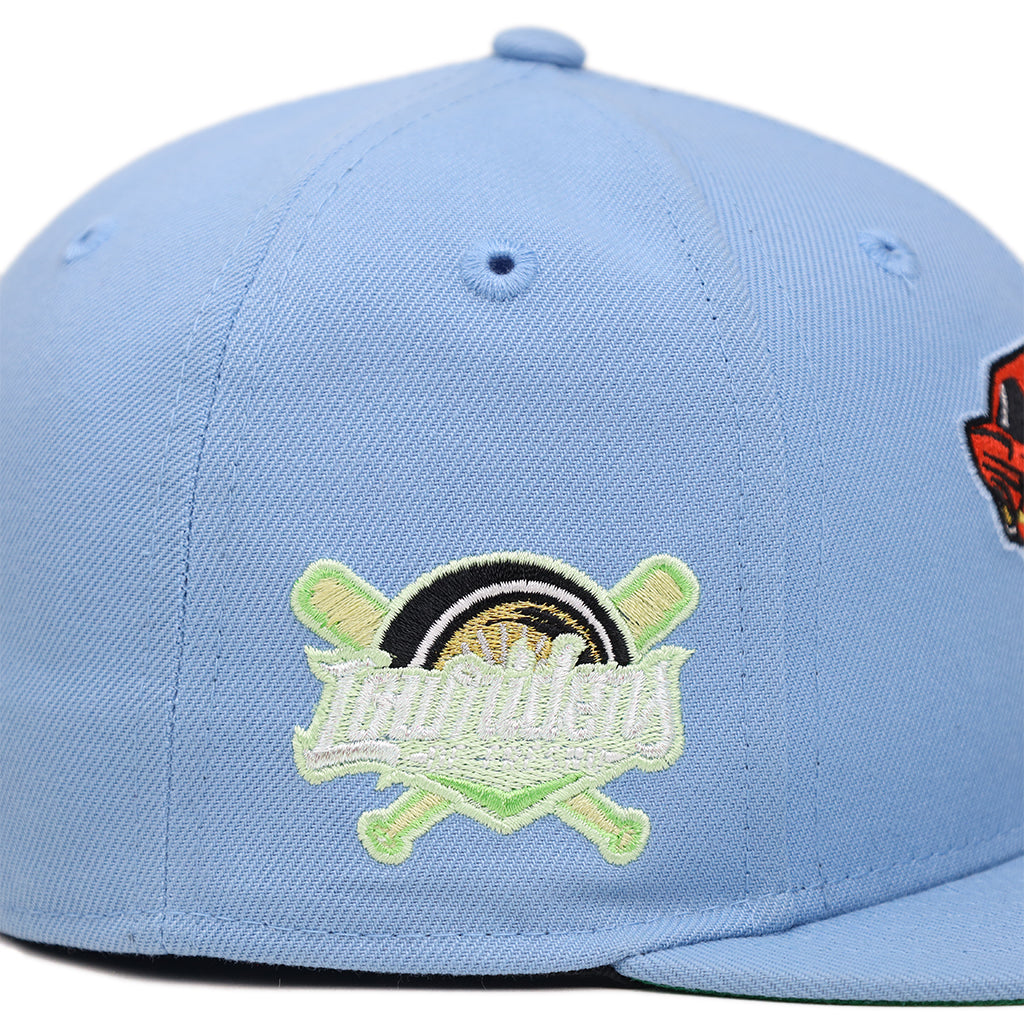 Side profile of light blue Fresno Grizzlies Lowriders fitted hat showing crossed bats patch