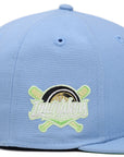 Side profile of light blue Fresno Grizzlies Lowriders fitted hat showing crossed bats patch